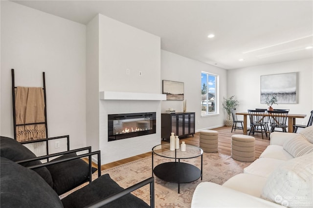 15507 65th Avenue Ct E, Puyallup, WA 98375 - living room featuring wood finished floors, a glass covered fireplace, and recessed lighting