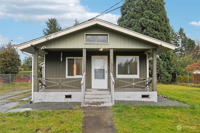 bungalow-style house featuring a porch and a front yard