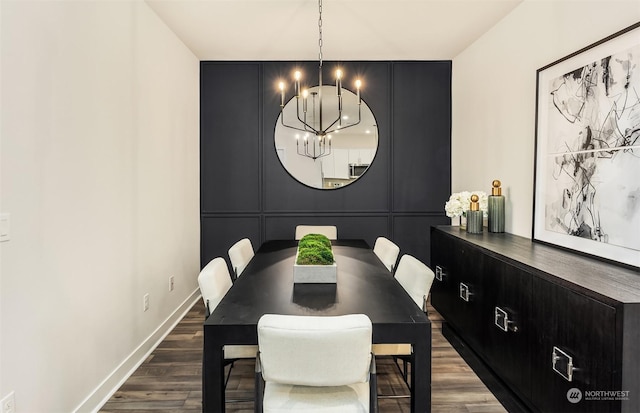 dining area featuring dark hardwood / wood-style flooring and a chandelier