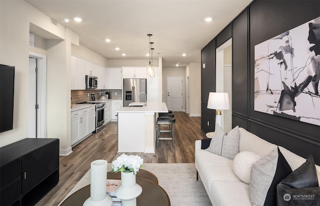 living room featuring sink and dark hardwood / wood-style floors