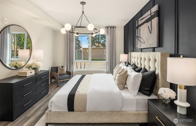 bedroom featuring a notable chandelier and light hardwood / wood-style flooring