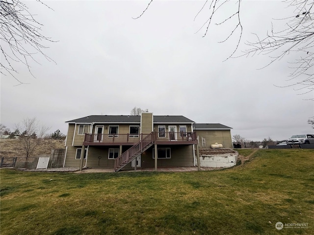 back of house with a wooden deck, a patio area, and a yard