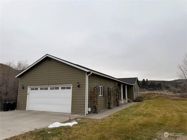 view of side of home with a lawn and a garage