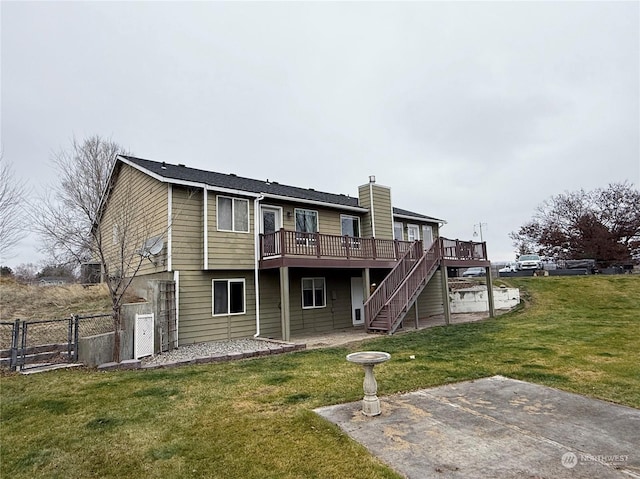 back of house featuring a yard, a patio, and a wooden deck