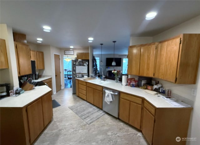 kitchen with decorative light fixtures, stainless steel dishwasher, and sink