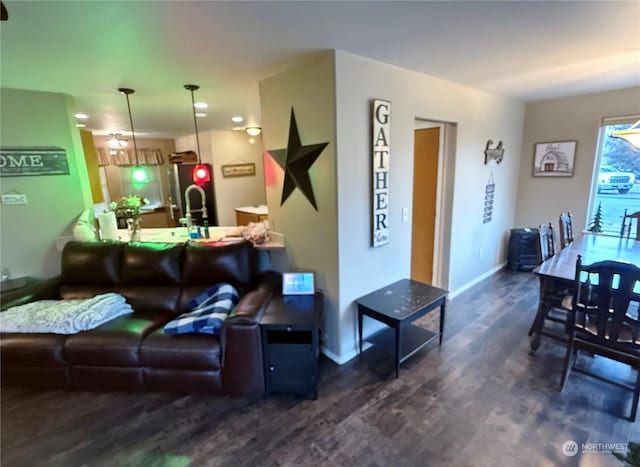 living room with dark hardwood / wood-style floors and sink