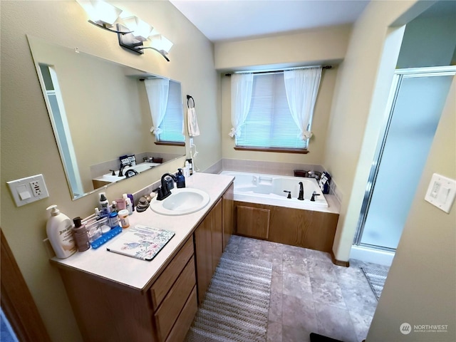 bathroom with vanity and shower with separate bathtub