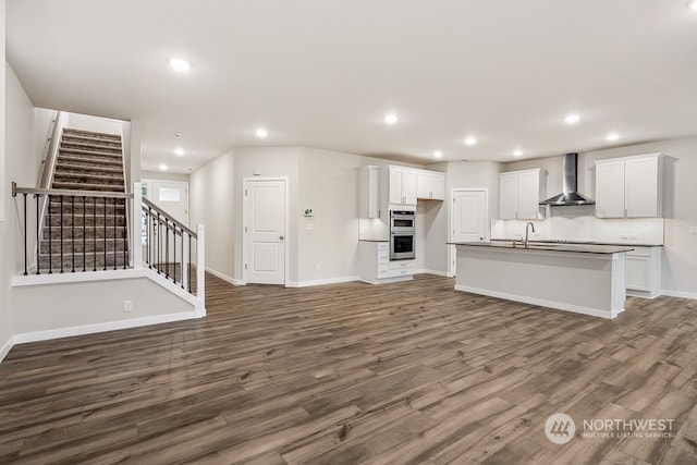 unfurnished living room with dark hardwood / wood-style flooring and sink