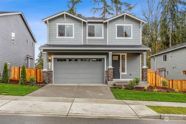 craftsman inspired home with a front lawn and a garage