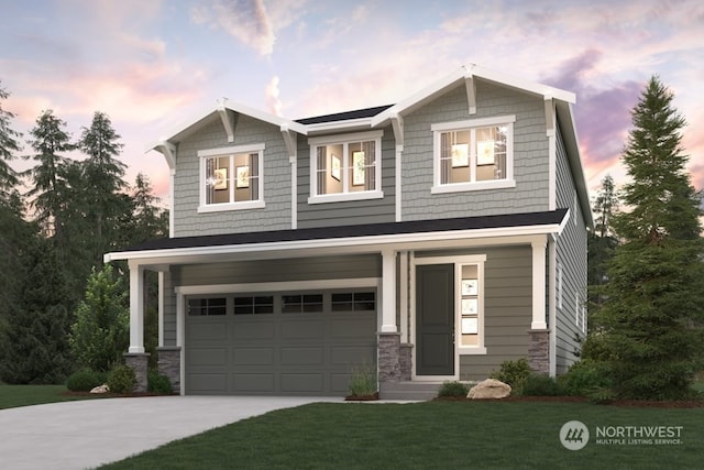 craftsman inspired home with concrete driveway, an attached garage, a front yard, and stone siding