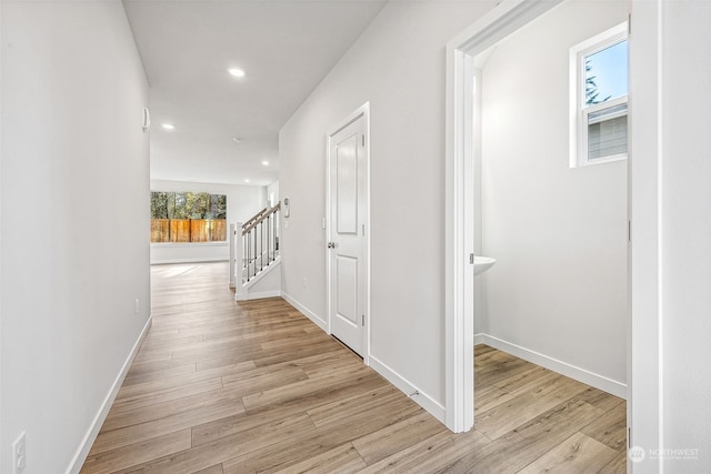 corridor with stairs, recessed lighting, baseboards, and light wood-type flooring