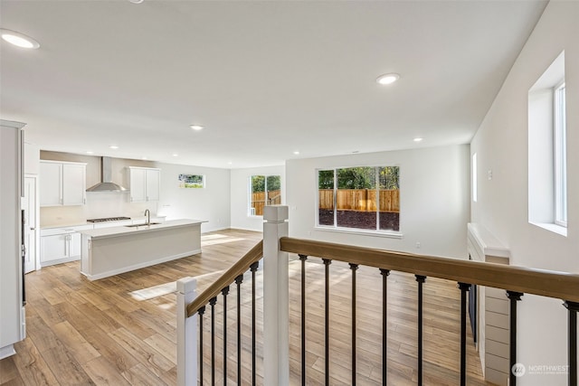 interior space with a sink, light wood-style floors, and recessed lighting