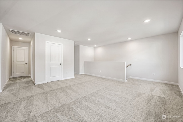 basement featuring recessed lighting, visible vents, light carpet, and baseboards