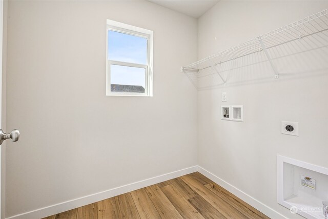 laundry room with baseboards, laundry area, hookup for a washing machine, light wood-style flooring, and electric dryer hookup