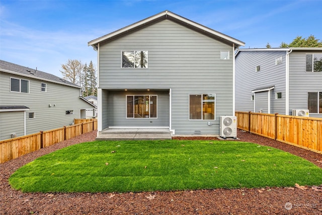 back of property with a patio, a lawn, and a fenced backyard