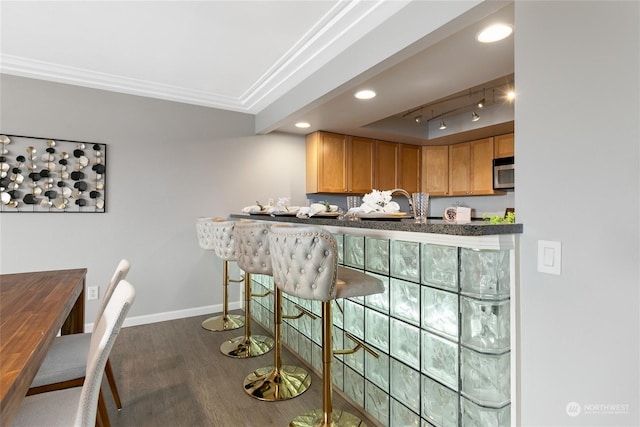 kitchen featuring dark hardwood / wood-style flooring and rail lighting