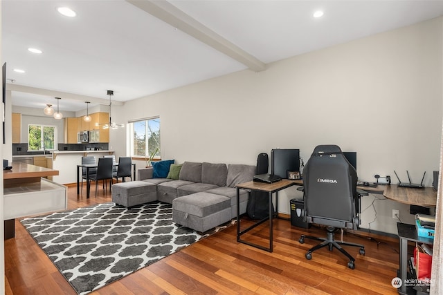 home office featuring beam ceiling and wood-type flooring