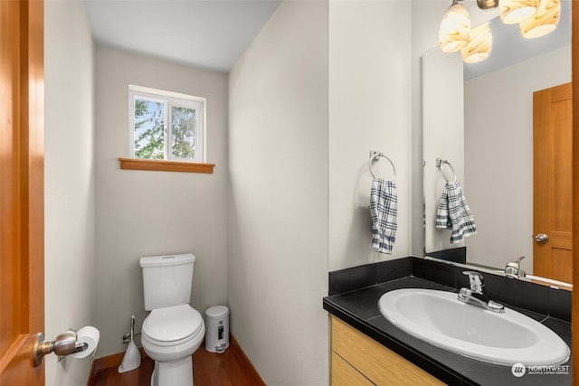 bathroom featuring hardwood / wood-style floors, vanity, and toilet