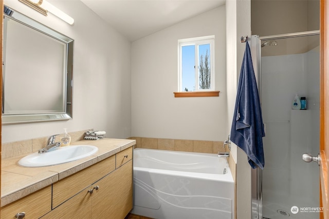 bathroom featuring plus walk in shower, vanity, and vaulted ceiling