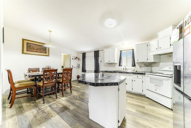 kitchen with white cabinetry, electric range, a center island, and hardwood / wood-style flooring