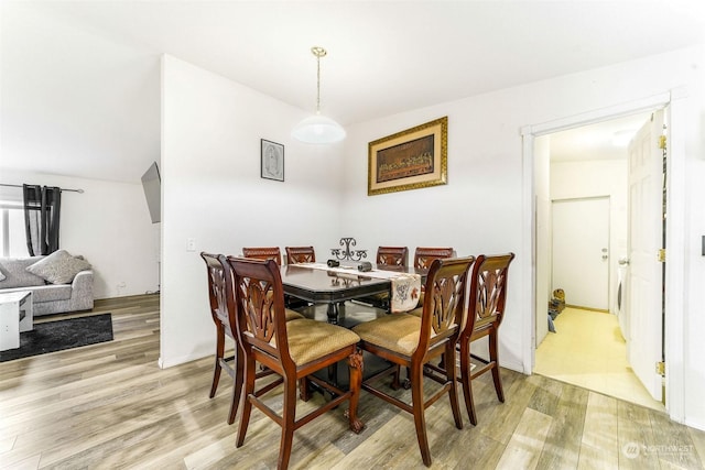 dining space with light hardwood / wood-style flooring