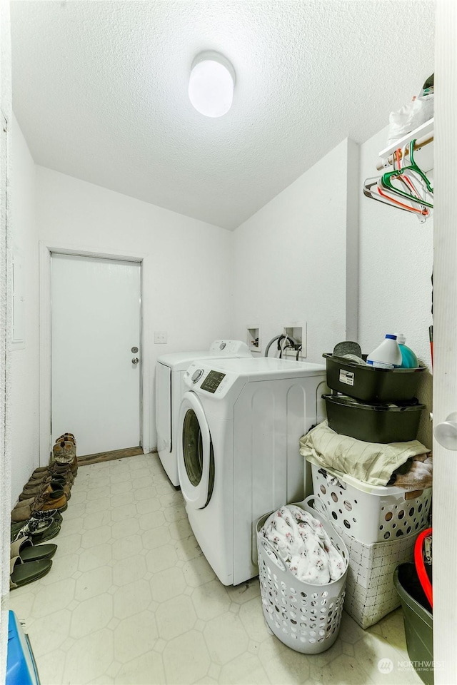 washroom featuring washer and dryer and a textured ceiling