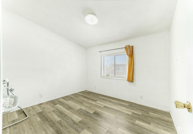 spare room featuring hardwood / wood-style floors