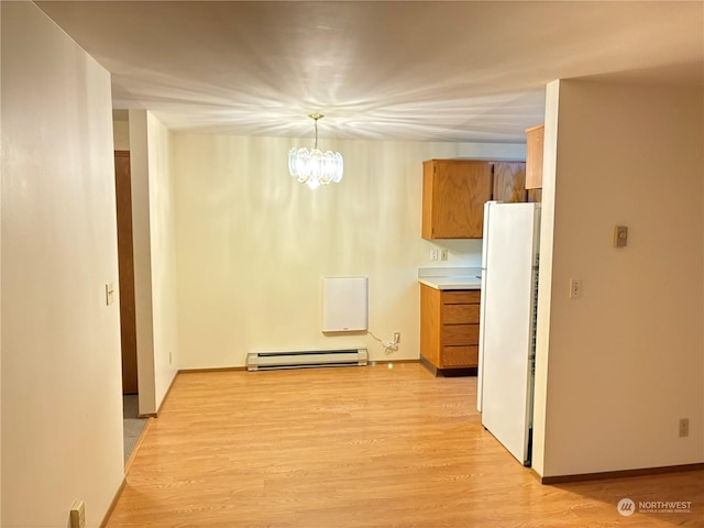 hall with baseboard heating, light hardwood / wood-style floors, and a notable chandelier