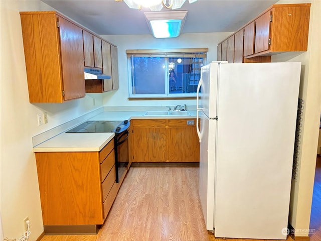 kitchen with light wood-type flooring, white refrigerator, black electric range, and sink