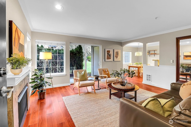 living room with hardwood / wood-style flooring and ornamental molding