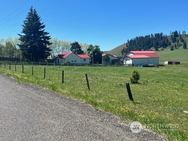 view of yard with a rural view