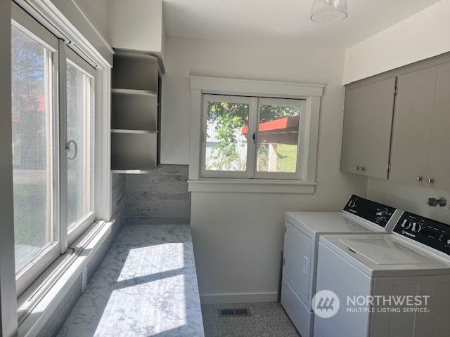 laundry room with cabinets and washing machine and dryer