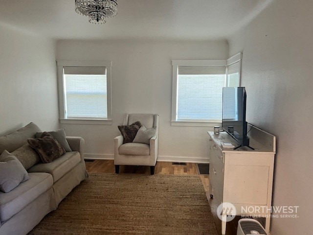 living room featuring dark hardwood / wood-style floors and a notable chandelier