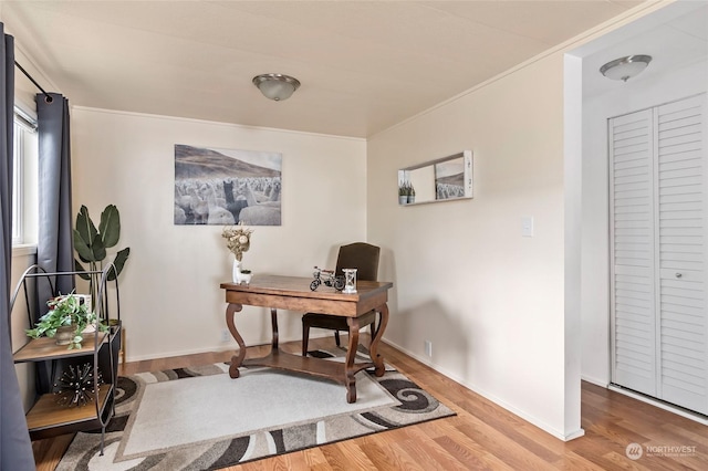 home office featuring hardwood / wood-style flooring and crown molding