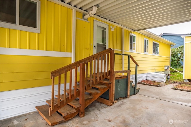 view of exterior entry with a patio area