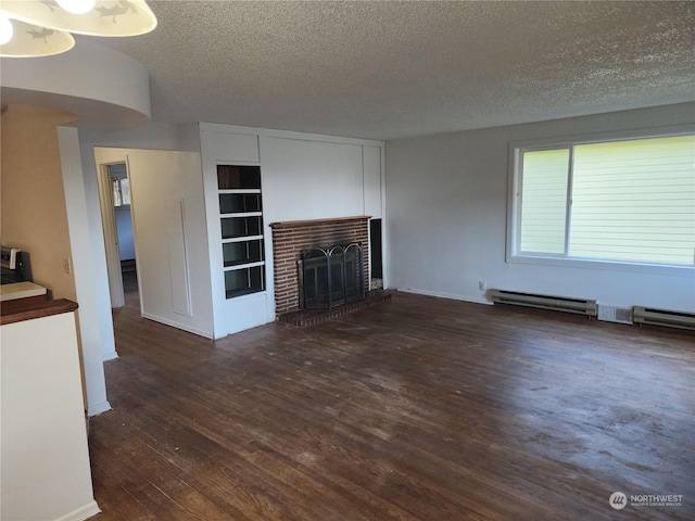 unfurnished living room featuring a textured ceiling, dark hardwood / wood-style floors, and a brick fireplace