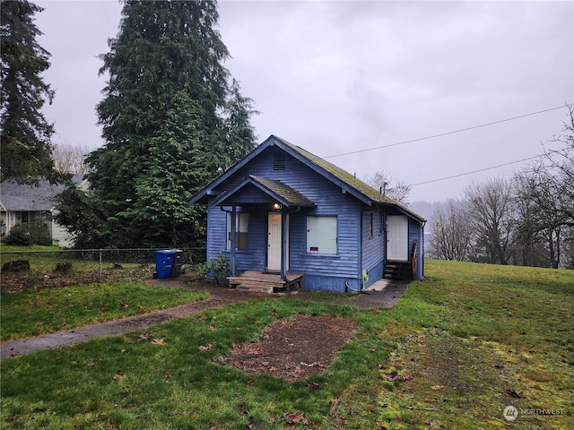 bungalow-style home with a front lawn