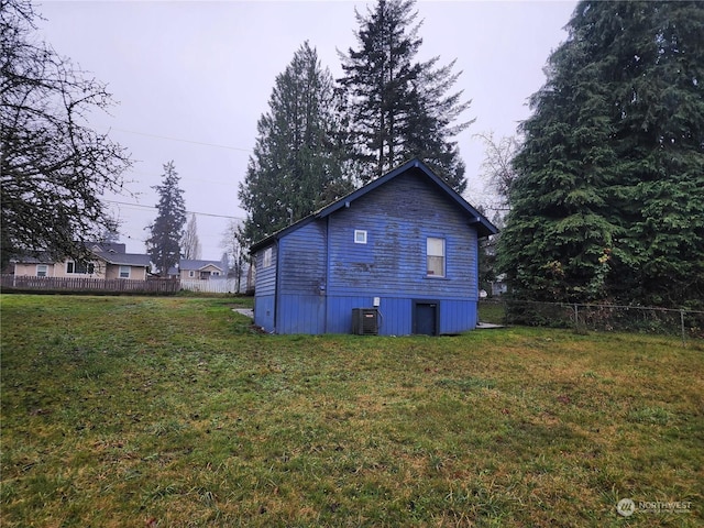 view of property exterior with cooling unit and a lawn