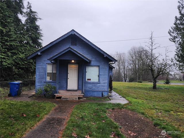 bungalow-style house with a front yard