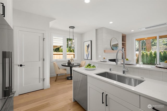 kitchen with sink, hanging light fixtures, plenty of natural light, and appliances with stainless steel finishes