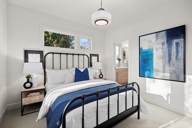 bedroom featuring carpet floors and connected bathroom