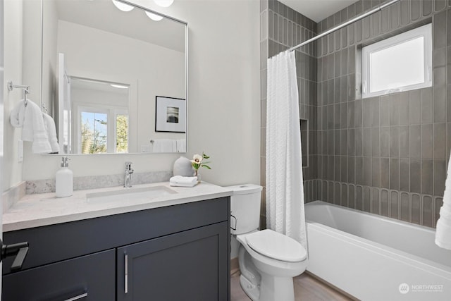 full bathroom featuring vanity, toilet, and shower / tub combo