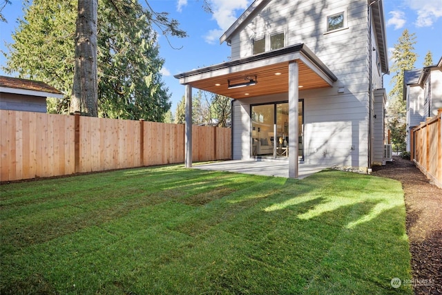 rear view of house with a yard, a patio, and central AC unit