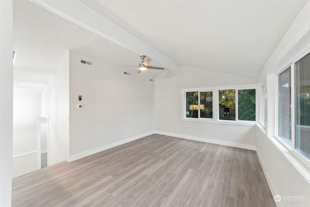 spare room with vaulted ceiling with beams, ceiling fan, and light wood-type flooring