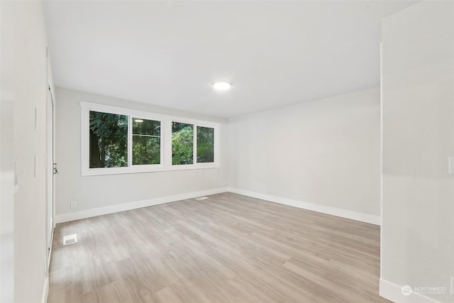 empty room with light hardwood / wood-style floors