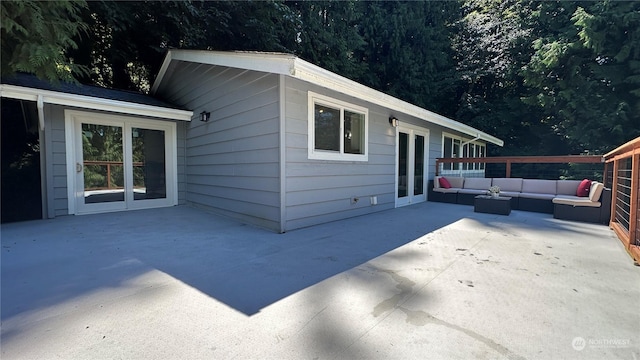 view of side of property with an outdoor living space and a patio area