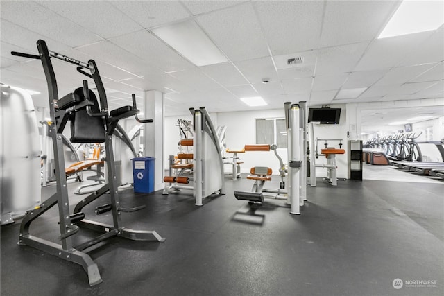 exercise room featuring a paneled ceiling