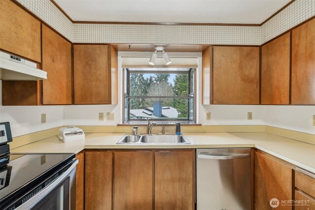 kitchen with a sink, stainless steel appliances, light countertops, under cabinet range hood, and brown cabinets