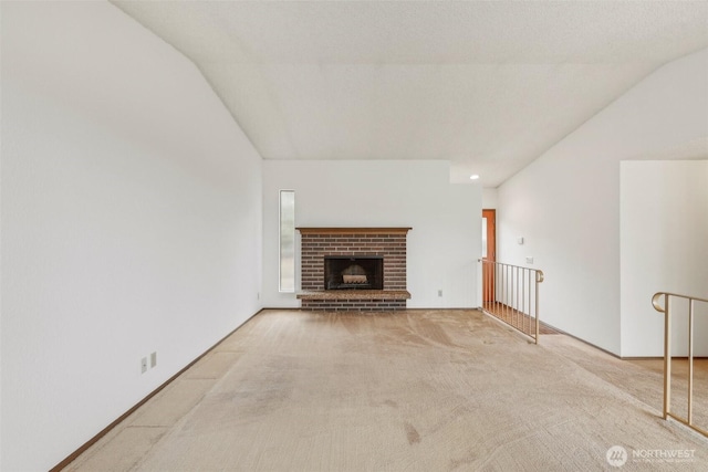 unfurnished living room featuring carpet flooring and a fireplace