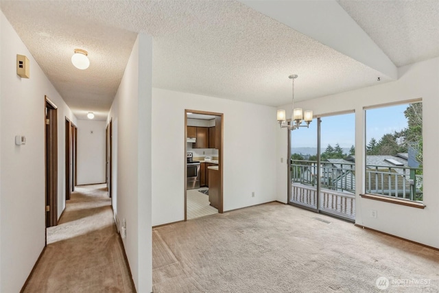 unfurnished dining area with a textured ceiling, visible vents, a chandelier, and light carpet